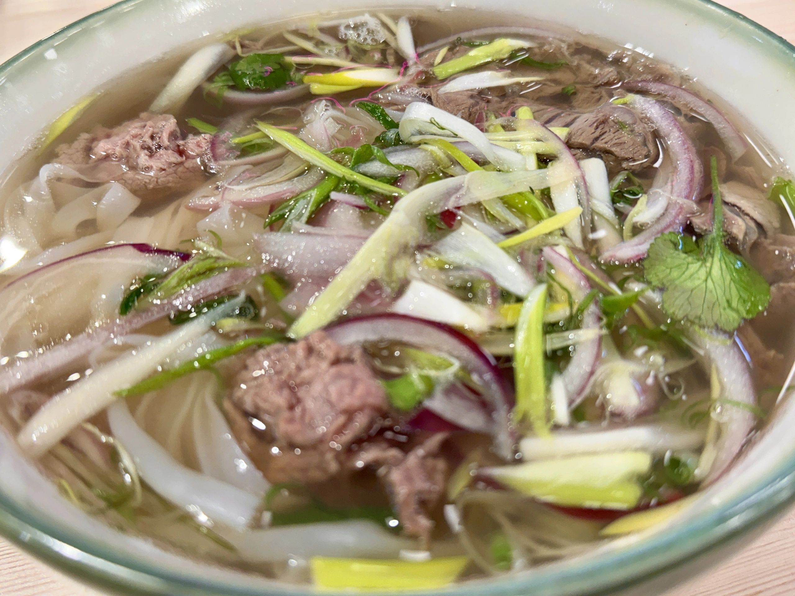 Beef pho with rice noodles, herbs, and lime